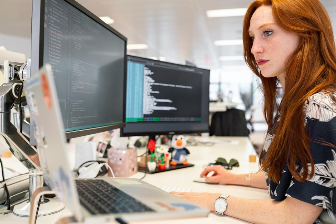 A woman in an office researching request for proposal on her computer