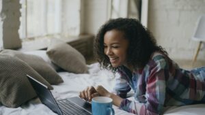 A calm person browsing an online store on a laptop in a cozy home